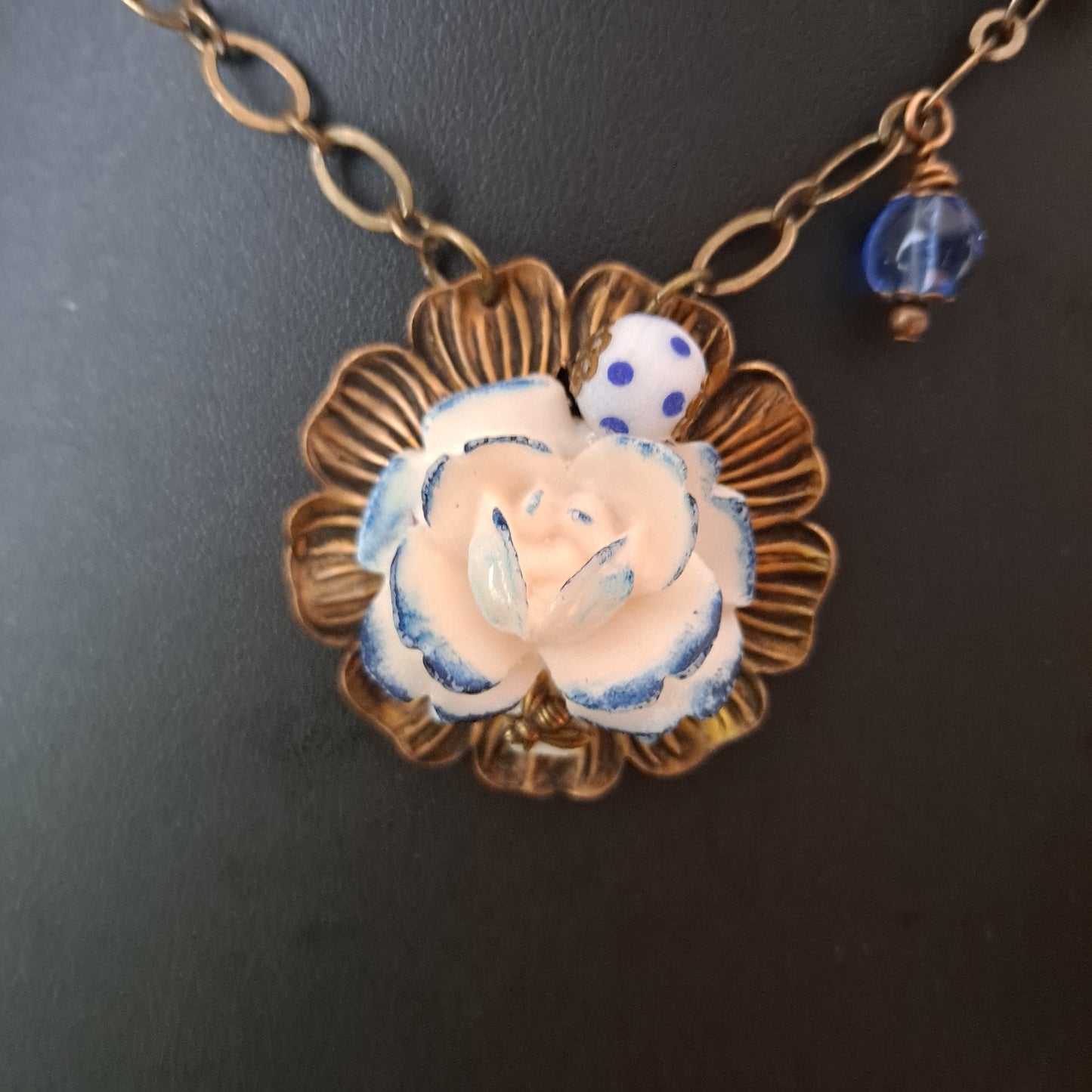 Matte brass necklace with white and blue flower cabochon, glass, ceramic and brass beads.